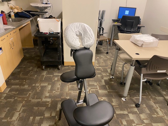 Chair massage equipment set up in a Sacramento corporate office breakroom