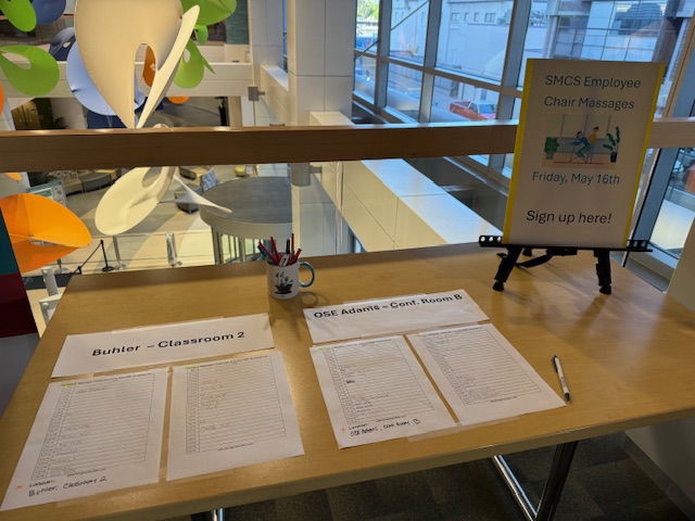 Sign-up table for on-site chair massage event coordination in Sacramento
